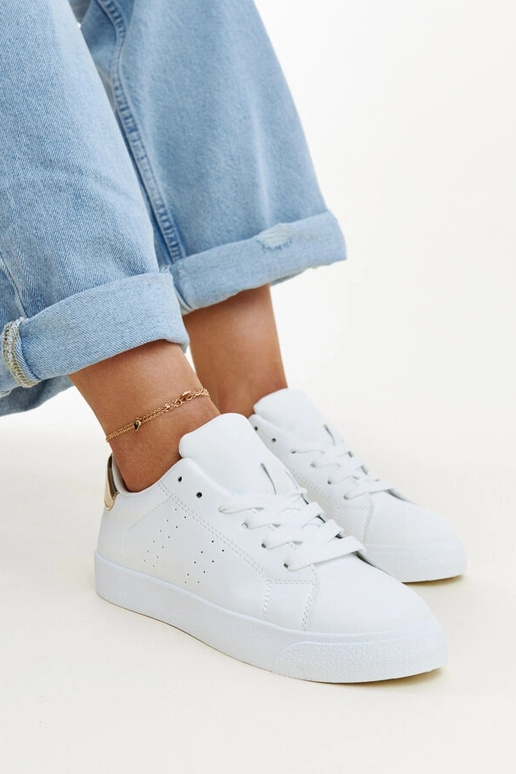 Akila baltas un zeltainas kedas