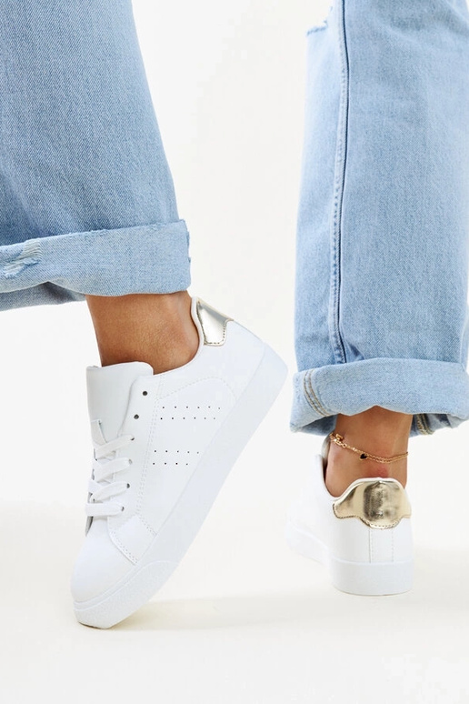 Akila baltas un zeltainas kedas