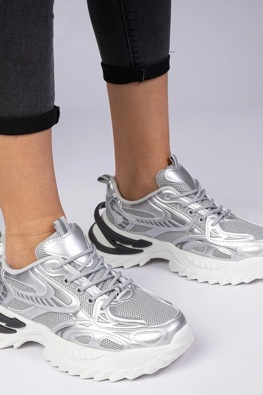 Sudraba sporta sneakers uz masīvas... Sudraba sporta sneakers uz masīvas...