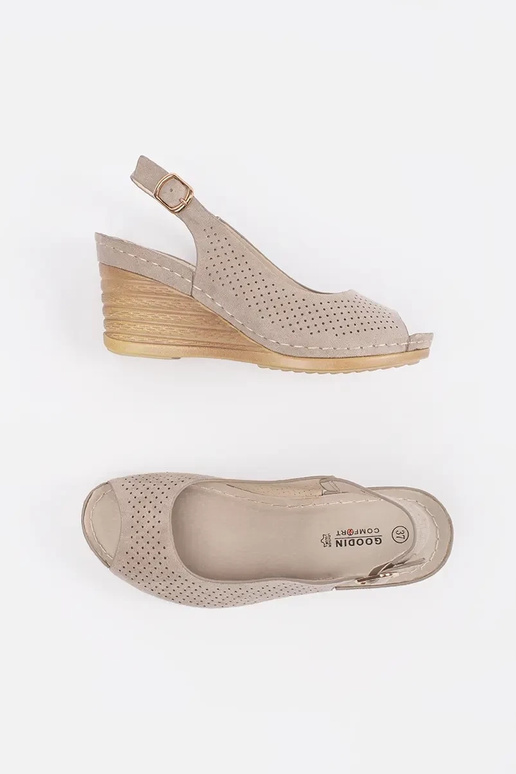 Caurumu sandales smilšu krāsā uz pleca