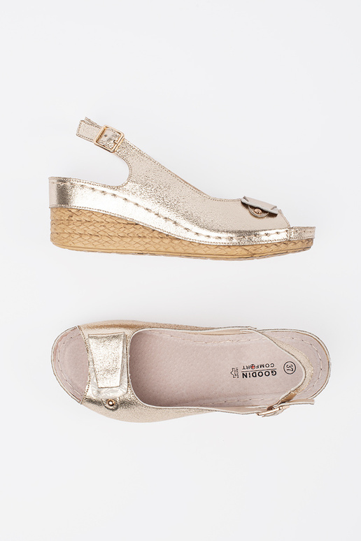 Zelta krāsas sandales uz zema pleisa