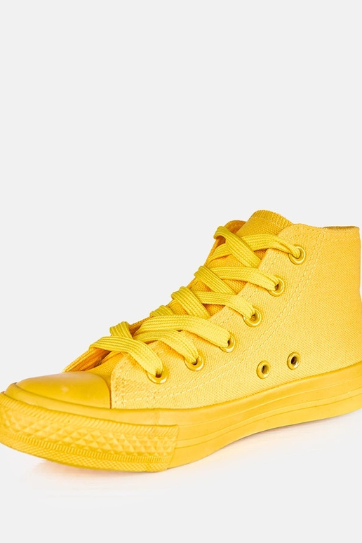 Dzelteni bērnu sporta apavi virs...