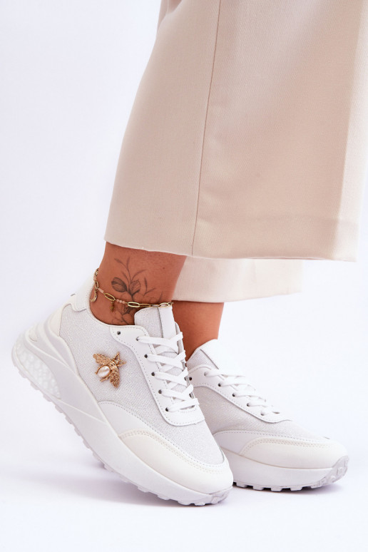 Mirdzoši sporta apavi ar ornamentiem baltas krāsas Seneca