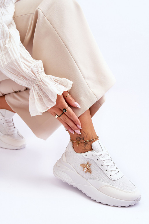 Mirdzoši sporta apavi ar ornamentiem baltas krāsas Seneca